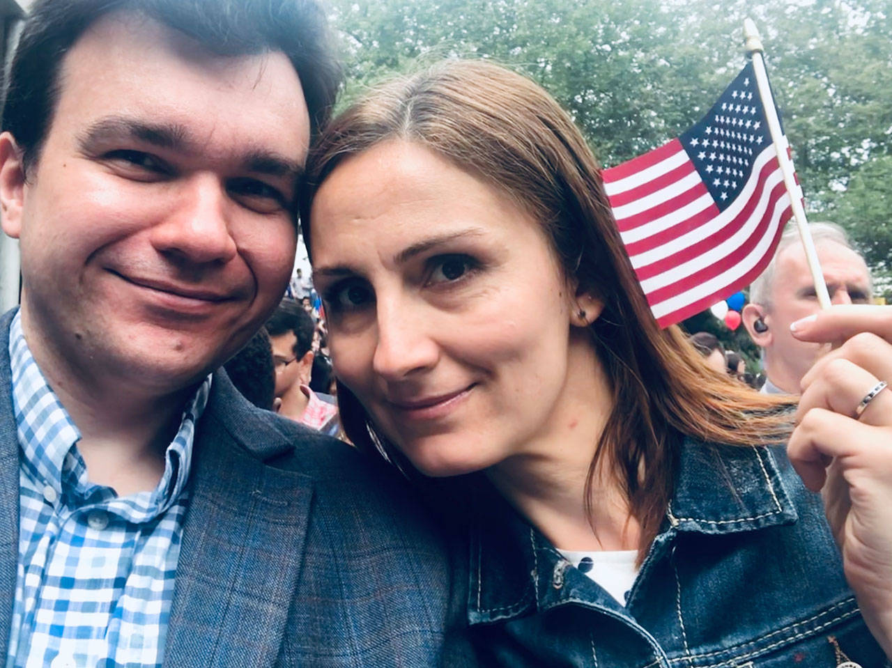 Photo courtesy of Ksenia Khokhlov                                Ksenia Khokhlov (left) and her husband Anton Khokhlov are all smiles as they wait to be sworn in as U.S. citizens at the ceremony on July 4 at Seattle Center.