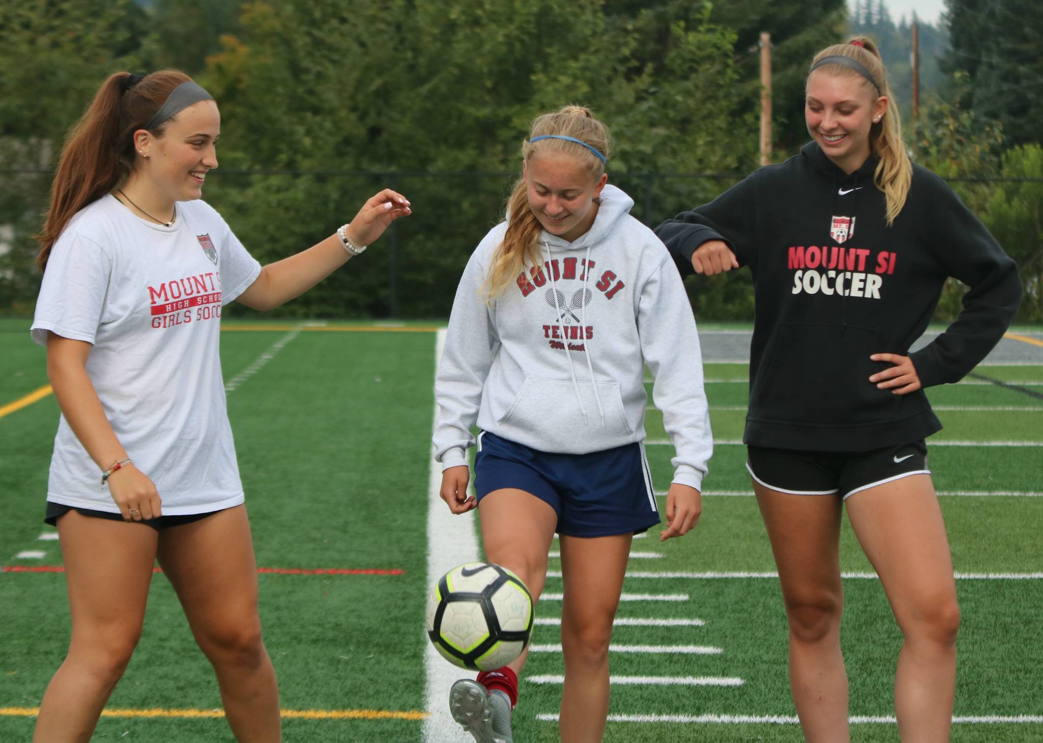 From left to right, Mount Si’s Izzy Smith, Sarah Creighton and Joelle Buck get their kicks at practice. Andy Nystrom/ staff photo