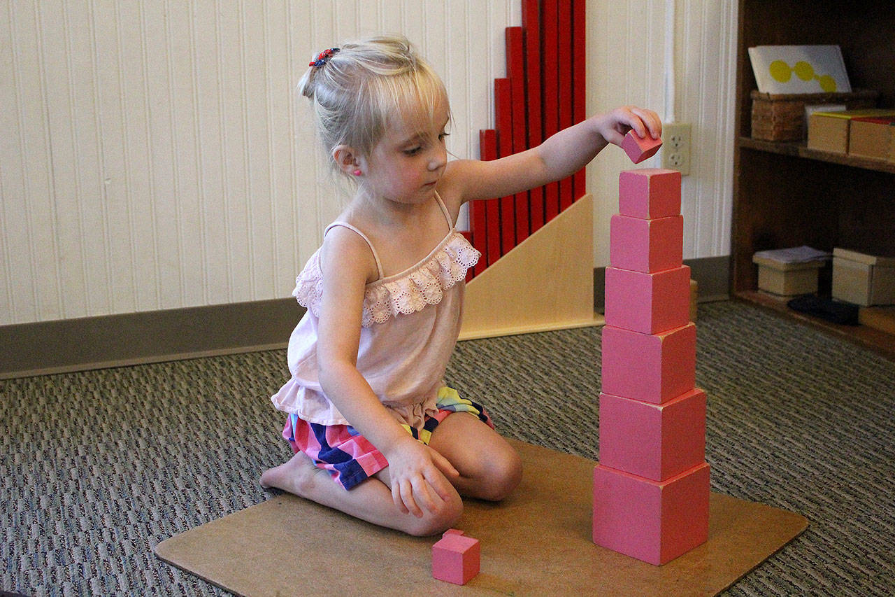 Photos by Madison Miller / staff photo                                Harper Lenihan, 4, plays with blocks at Mount Si Montessori.