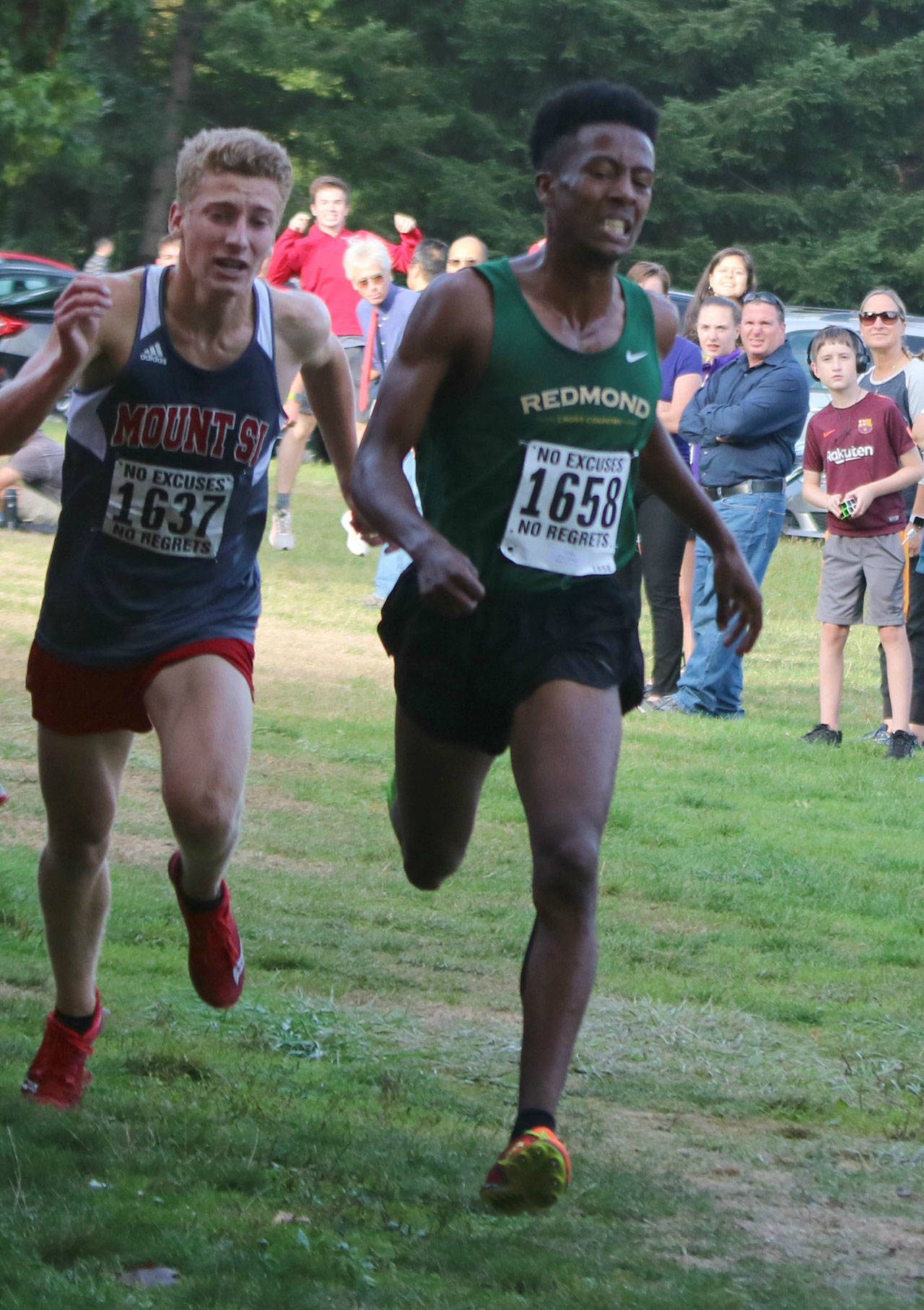 Mount Si’s Paul Talens, left, finishes second to Redmond’s Dereje Himbago in the junior boys two-mile race at the KingCo Jamboree on Sept. 11 at Lake Sammamish State Park. Andy Nystrom/ staff photo