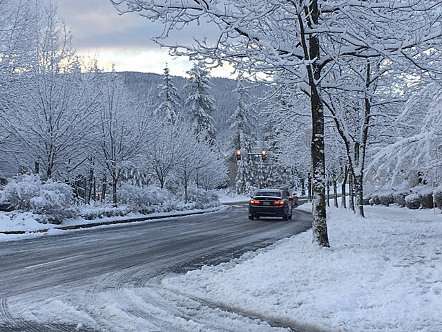Several roads in King County, including the Snoqualmie Parkway, were closed when a brief snow storm struck the region last February. File photo