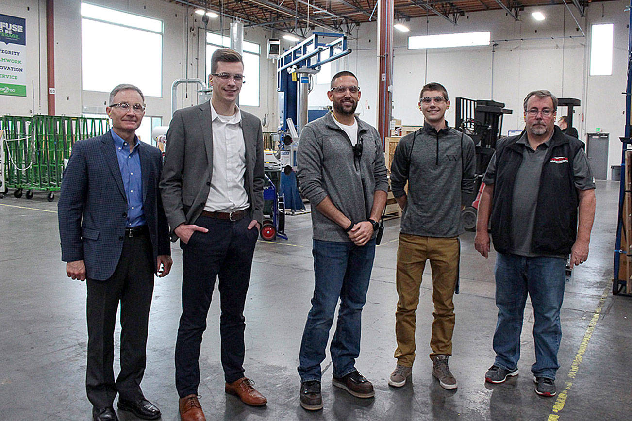 Natalie DeFord/Staff photo                                A group tours the facilities at Allegion (Technical Glass Products) during the company’s Manufacturing Day event. From left, Snoqualmie city administrator Bob Larson, Casey Duff from Sen. Maria Cantwell’s office, production manager Dave Jensen, Mount Si High School senior Dylan Van Vleet, Mount Si teacher Gregg Meyers.