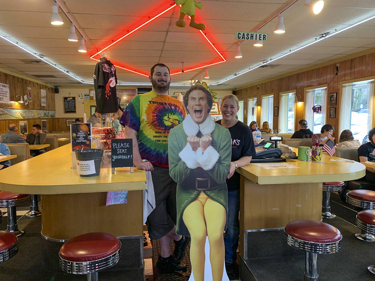 Jacob Pass and Anita Young at Twede’s Cafe with Buddy the Elf during a North Bend Downtown Foundation photo campaign promoting downtown businesses. Natalie DeFord/staff photo