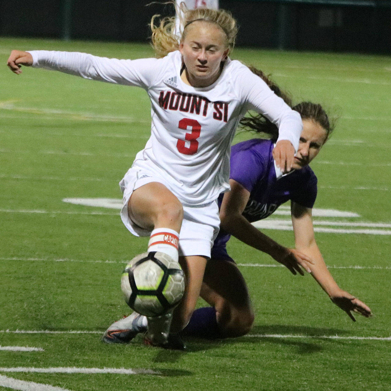 Mount Si’s Sarah Creighton battles a North Creek player for the ball this season. Andy Nystrom/ staff photo