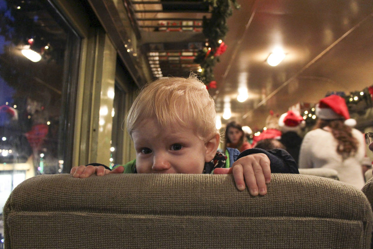 One-year-old Julian Gale says hello to the passengers behind him on the Santa Train.