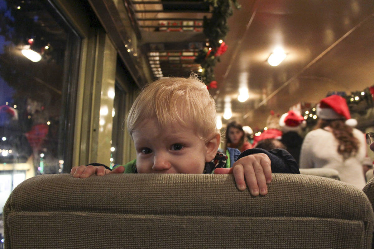 One-year-old Julian Gale says hello to the passengers behind him on the Santa Train.
