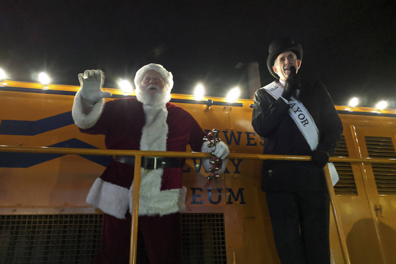 Santa waves to the crowd as Snoqualmie Mayor Matt Larson leads the crowd in an acapella version of “Santa Claus is Coming to Town” during the annual Winter Lights on Dec. 7. Corey Morris/staff photo