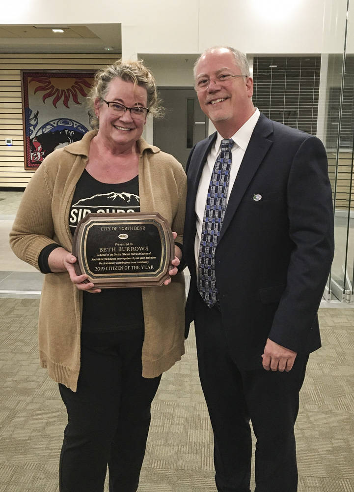 Courtesy photo                                North Bend Mayor Rob McFarland (R) presents the 2019 Citizen of the Year award to North Bend resident Beth Burrows at the city’s Feb. 4, 2020 council meeting.
