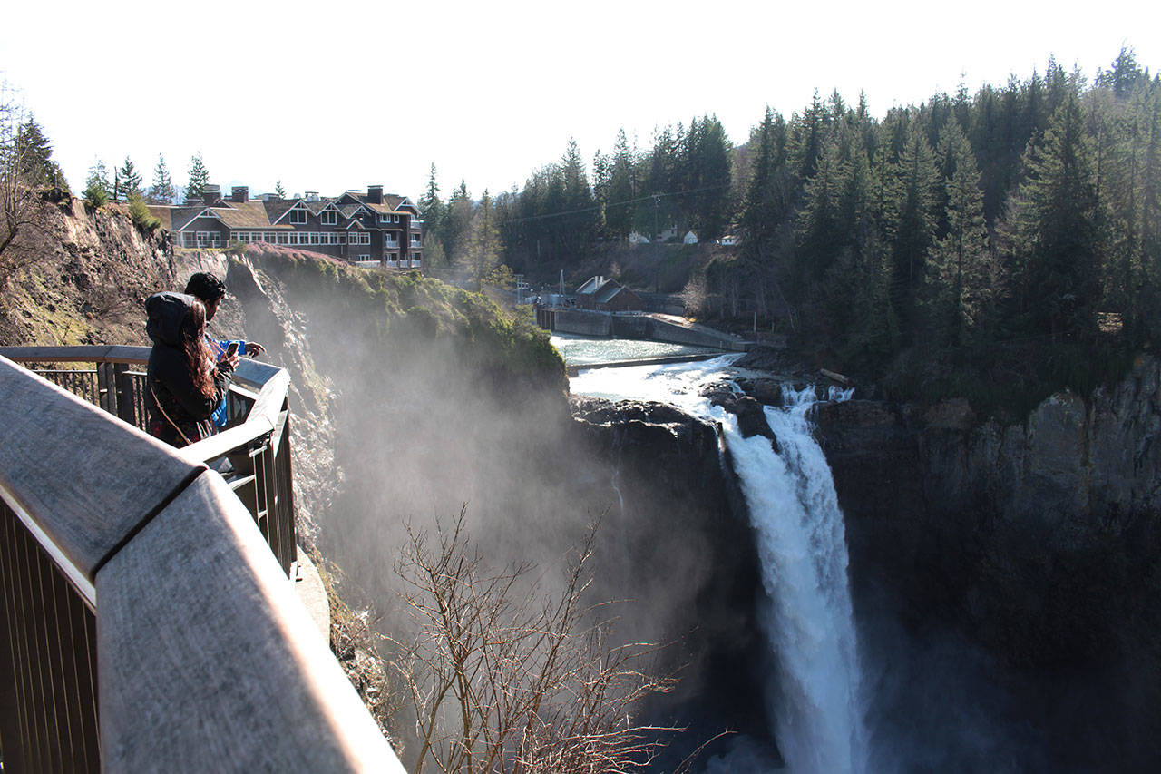People enjoying the view of Snoqualmie Falls and the Salish Lodge Spa in the sunshine on Feb. 19, 2020. Natalie DeFord/staff photo