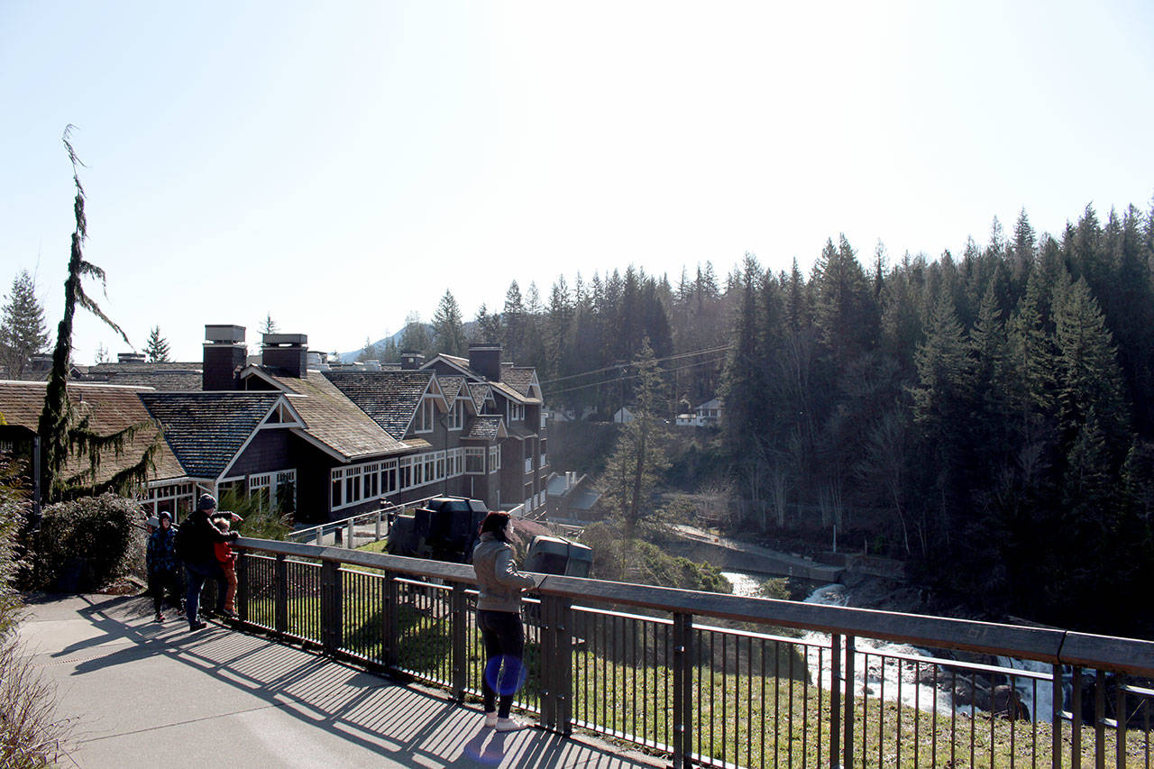 Sightseers at a Snoqualmie Falls viewpoint adjacent to the Salish Lodge Spa on Feb. 19, 2020. Natalie DeFord/staff photo