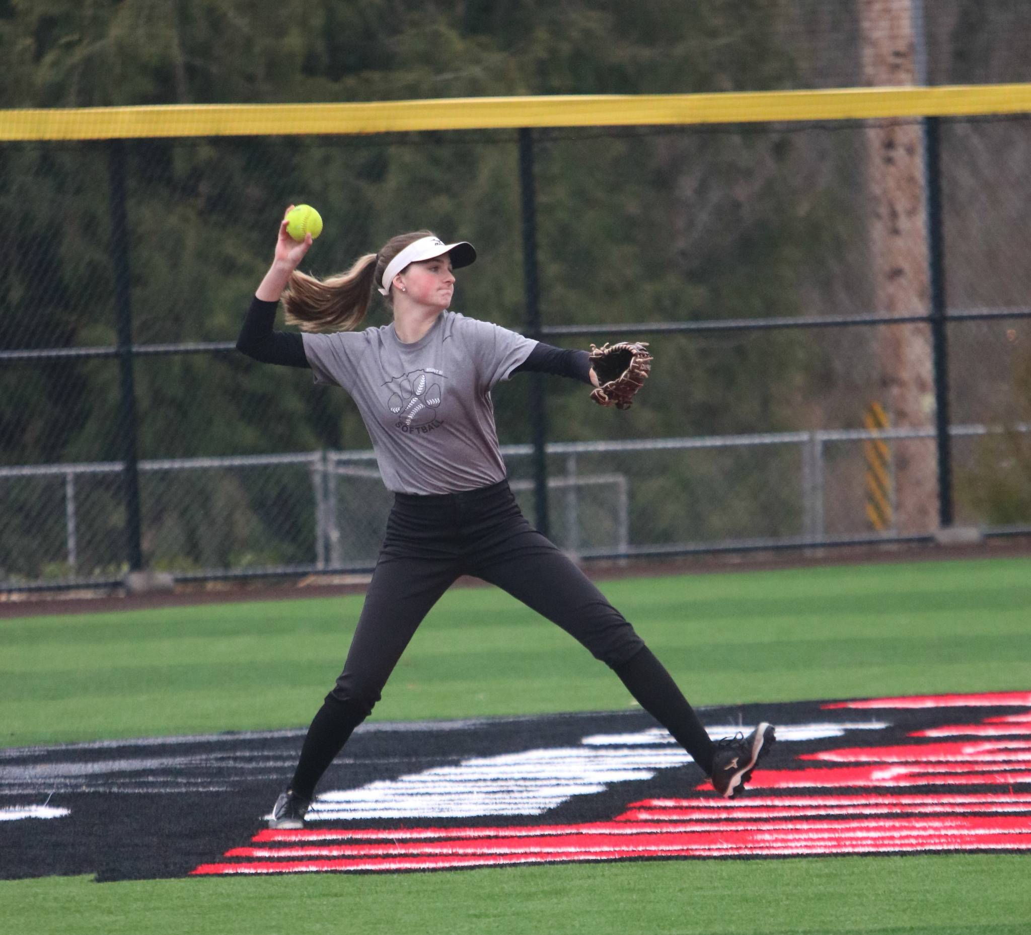 Molly Wilbourne makes a play in center field during a March 10 practice on the team’s new turf field. Andy Nystrom/ staff photo