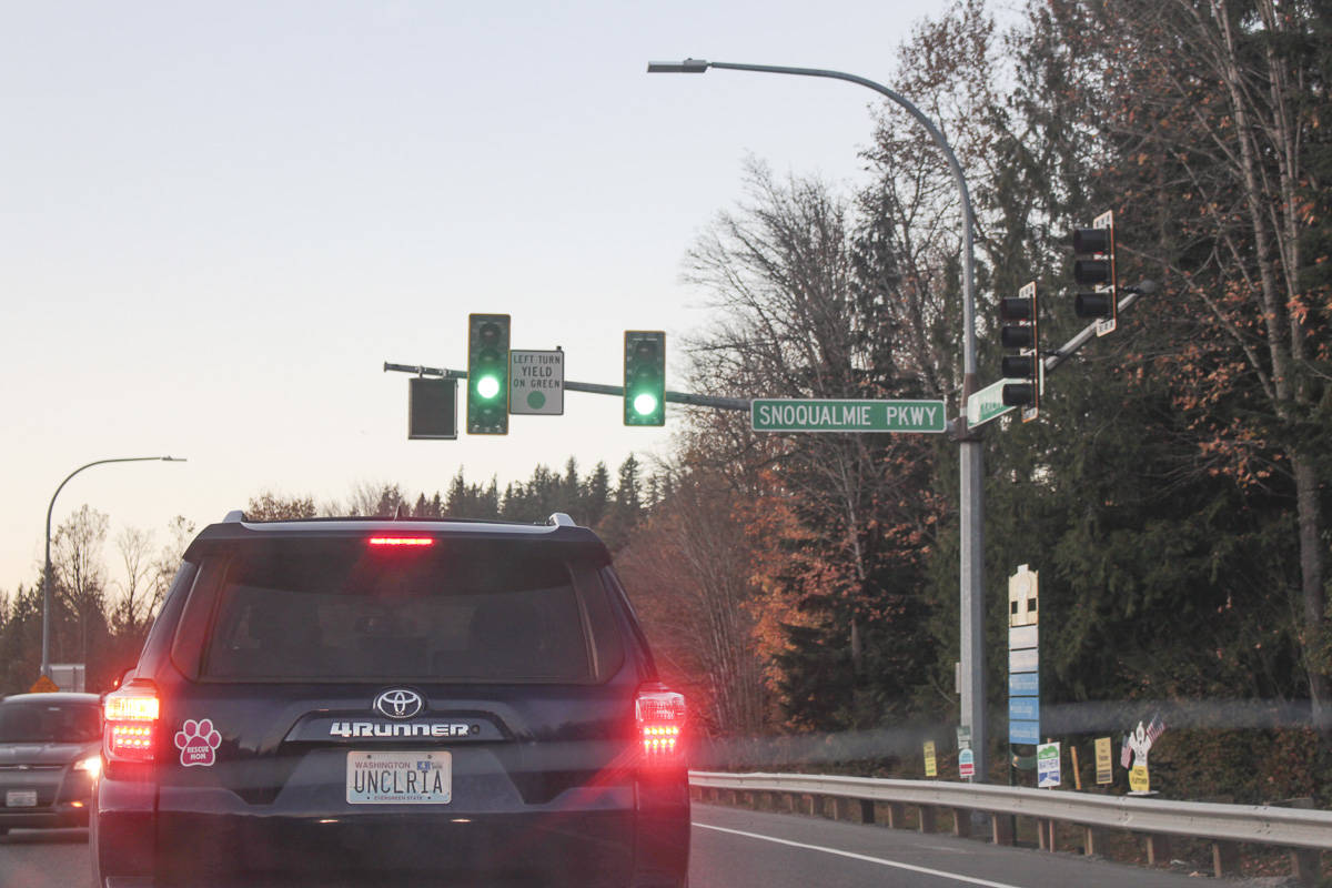 Cars drive in Snoqualmie at sunset. Natalie DeFord/staff photo
