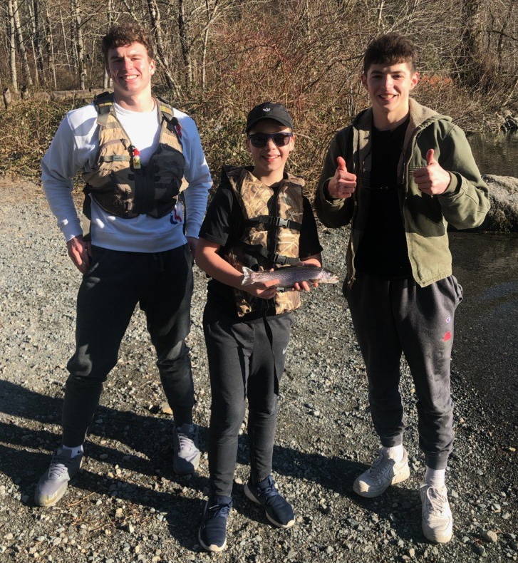 Caleb Dalgleish (left) and Charles-Grant Finney (right) with Chris Sant (middle) during one of their fishing trips. Courtesy photo