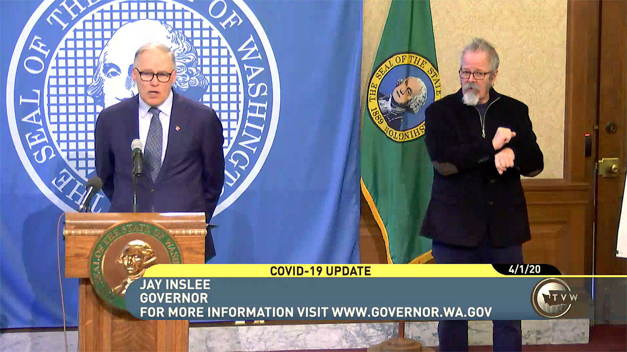 Gov. Jay Inslee (left) at a news conference in Olympia on Wednesday. (TVW)