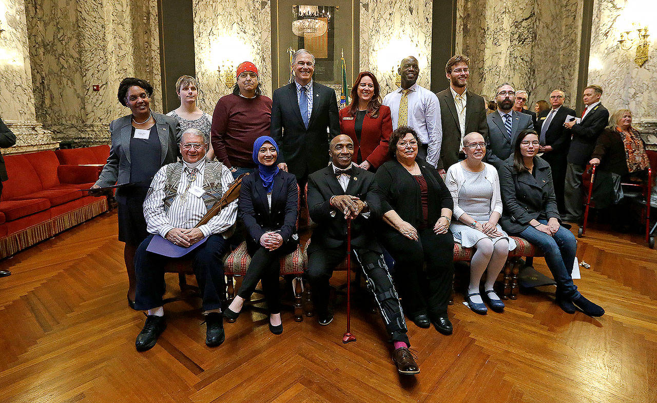 Democratic electors and state officials pose for a photo after a meeting of the states Electoral College in December 2016. Seated, from left, are Dan Carpita, Varisha Khan, Phillip Tyler, Julie Johnson, Elizabeth Caldwell and Levi Guerra. Standing, from left, are Esther John, Ryleigh Ivey, Robert Satiacum, Gov. Jay Inslee, Secretary of State Kim Wyman, Chris Porter, Eric Herde and Bret Chiafalo. Chiafalo, of Everett, along with John and Guerra did not cast their votes in the Electoral College for Democratic candidate Hillary Clinton, who won the states popular vote. (AP Photo/Elaine Thompson, file)