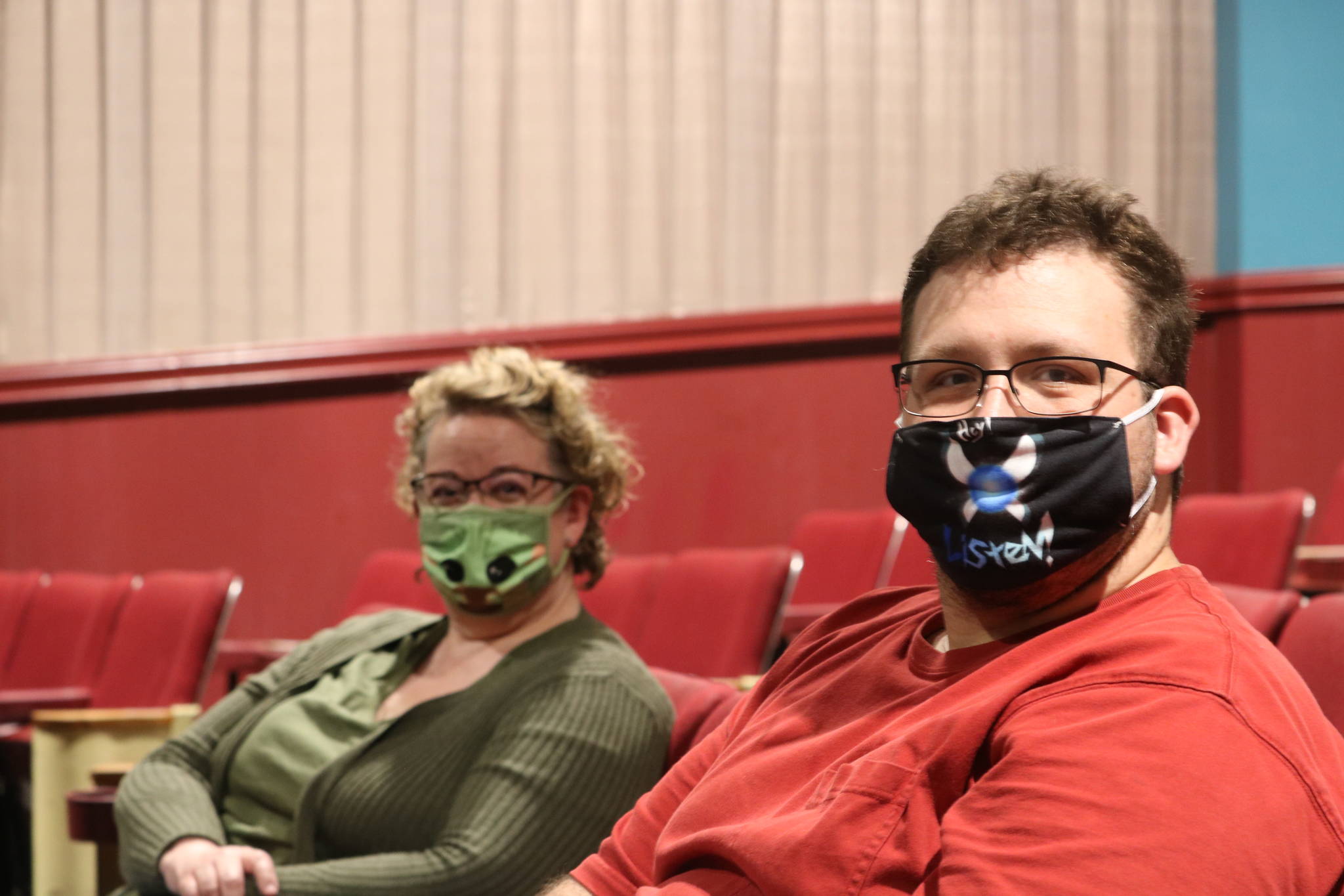 Beth Burrows, left, and Skyler Possert sit inside the North Bend Theatre. Aaron Kunkler/staff photo