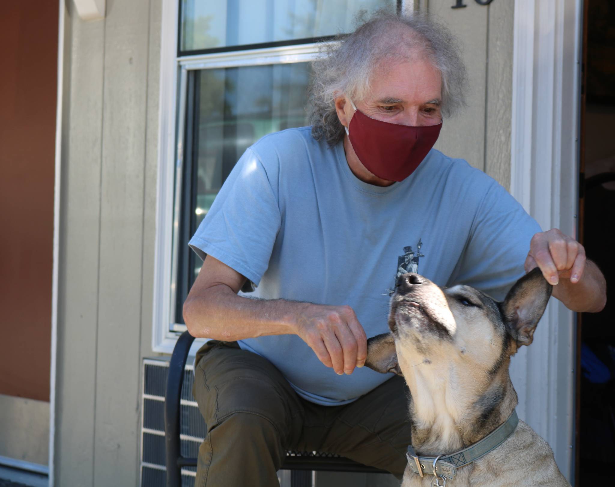 Robert Allen, 61, and his dog Jaxx have been living at the North Bend Motel since March, as part of a voucher program from Snoqualmie Valley Shelter Services. The stability a simple motel room provides is allowing Allen to heal from numerous injuries, and highlights the importance of providing shelter. Aaron Kunkler/staff photo