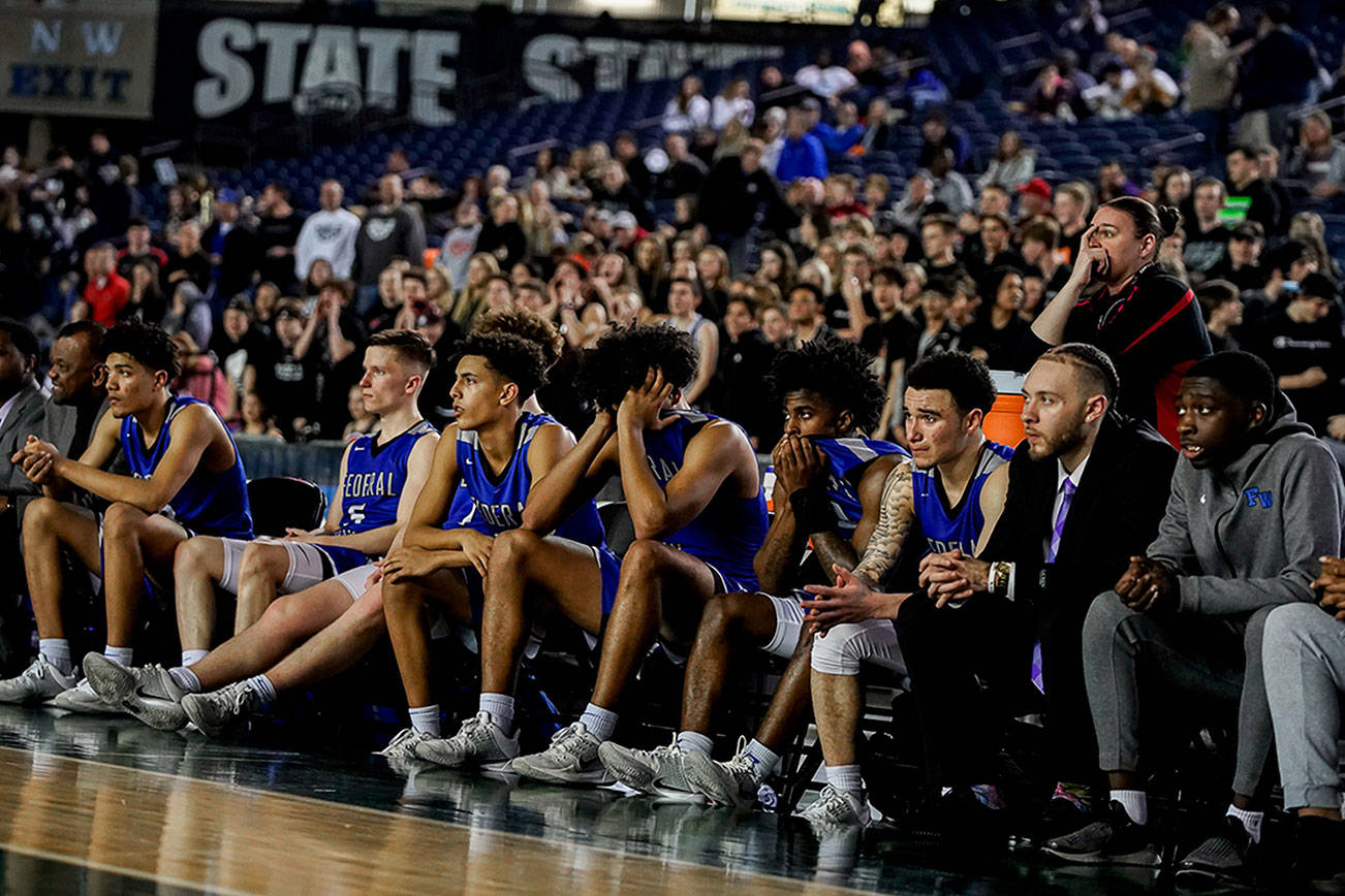 In this file photo from March 2020, the Federal Way High School boys basketball team reacts in the final minutes of the state quarterfinals game against Mt. Si High School. File photo
