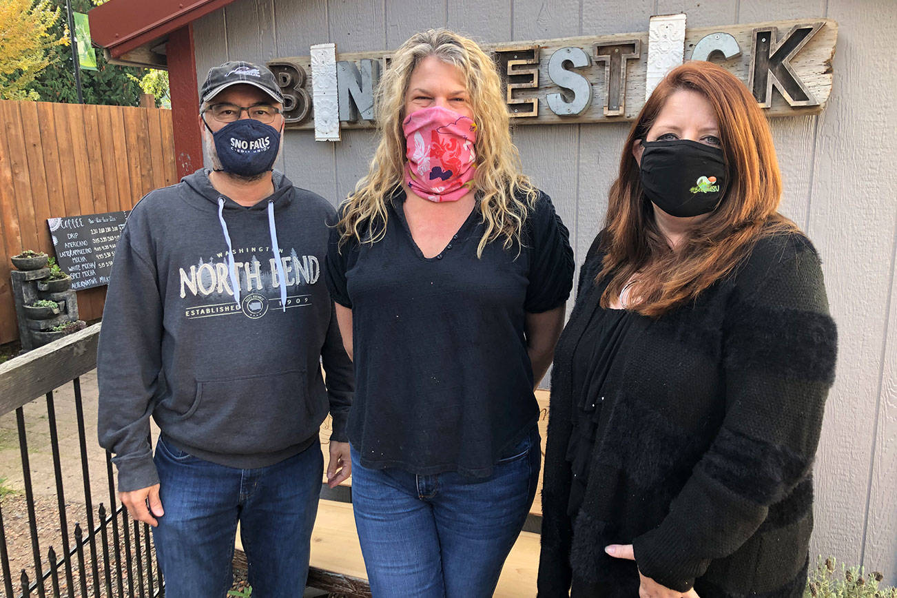 Andy Hobbs / staff photoValley merchants and the cities of North Bend, Snoqualmie and Fall City are co-hosting a Quarantine-O-Ween for Halloween festivities this year. Pictured left to right: Earl Bell, Board President, SnoValley Chamber of Commerce; Rachelle Armstrong, owner of The Bindlestick coffee shop in downtown Snoqualmie; and Kelly Coughlin, director of the SnoValley Chamber.