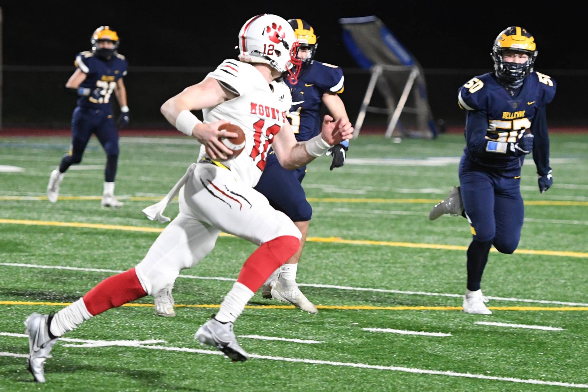 Mt. Si senior quarterback Clay Millen looks for a receiver to connect with during the Wildcats’ 23-13 victory over Bellevue on March 12, 2021. On one play in the second half, Millen broke free from three Bellevue tacklers and threw the ball 30 yards for a touchdown. Millen nailed two touchdown passes to Zach Soliday and one to Jacob Shaffer. Photo courtesy of Calder Productions