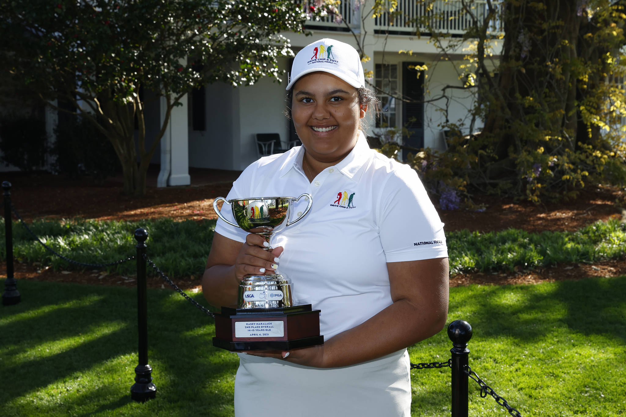 Contributed photo
Kasey Maralack in the Girls 14-15 age group holds her trophy during the Drive, Chip and Putt National Finals at Augusta National Golf Club, Sunday, April 4, 2021.