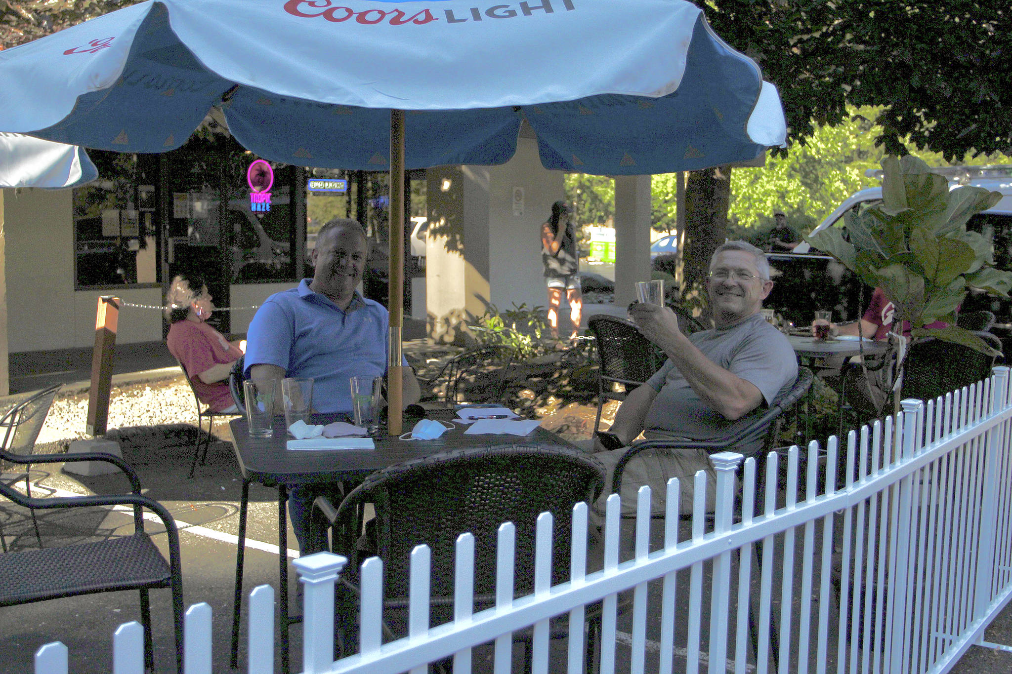 Federal Way residents Kevin Jochim, left, and Steve Reichel enjoy drinks on the new patio area at JPs Tavern on Aug. 5, 2020. Restaurants and bars embraced outdoor seating during the pandemic. File photo