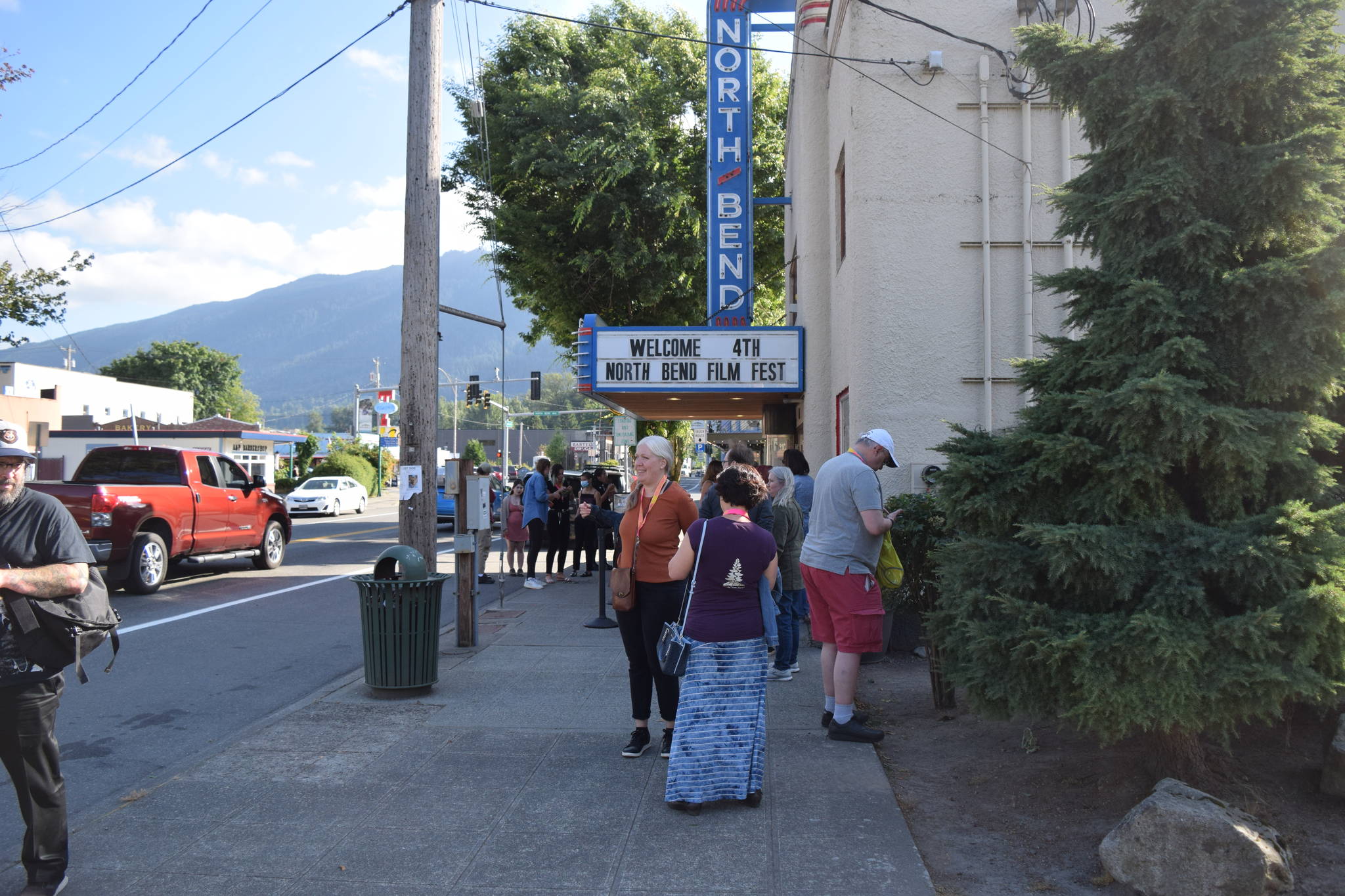 Residents wait outside the North Bend Theater on the opening night of North Bend Film Fest on Thursday, July 15. Photo by Conor Wilson/Valley Record