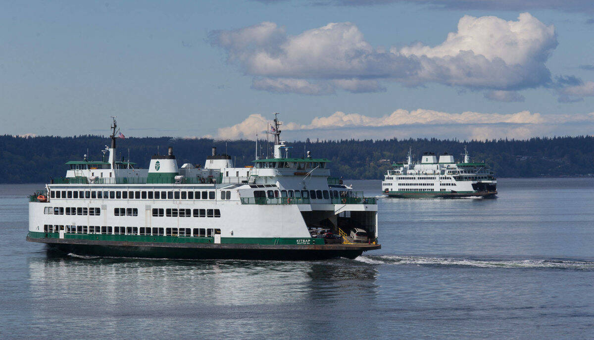 Ferries pass on a crossing between Mukilteo and Whidbey Island. File Photo by Andy Bronson/Daily Herald