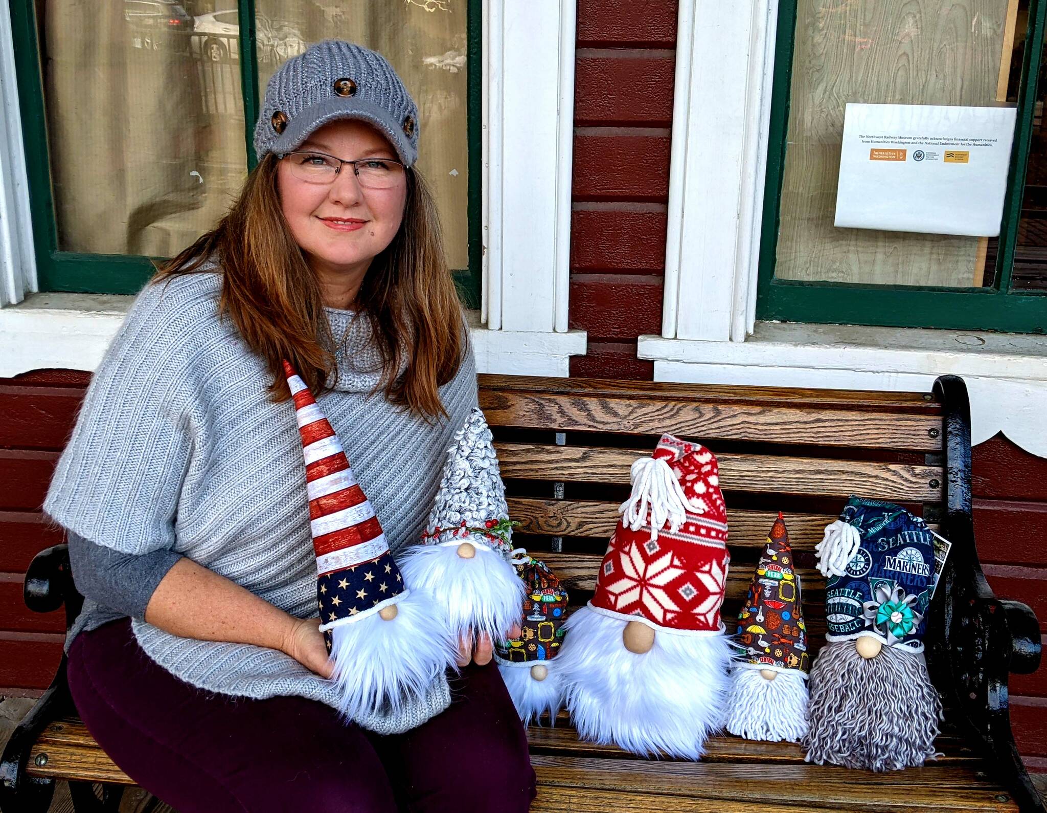 Marian Priegel, The Snoqualmie Gnome Maker, posses with gnomes she made. Photo by Conor Wilson/Valley Record