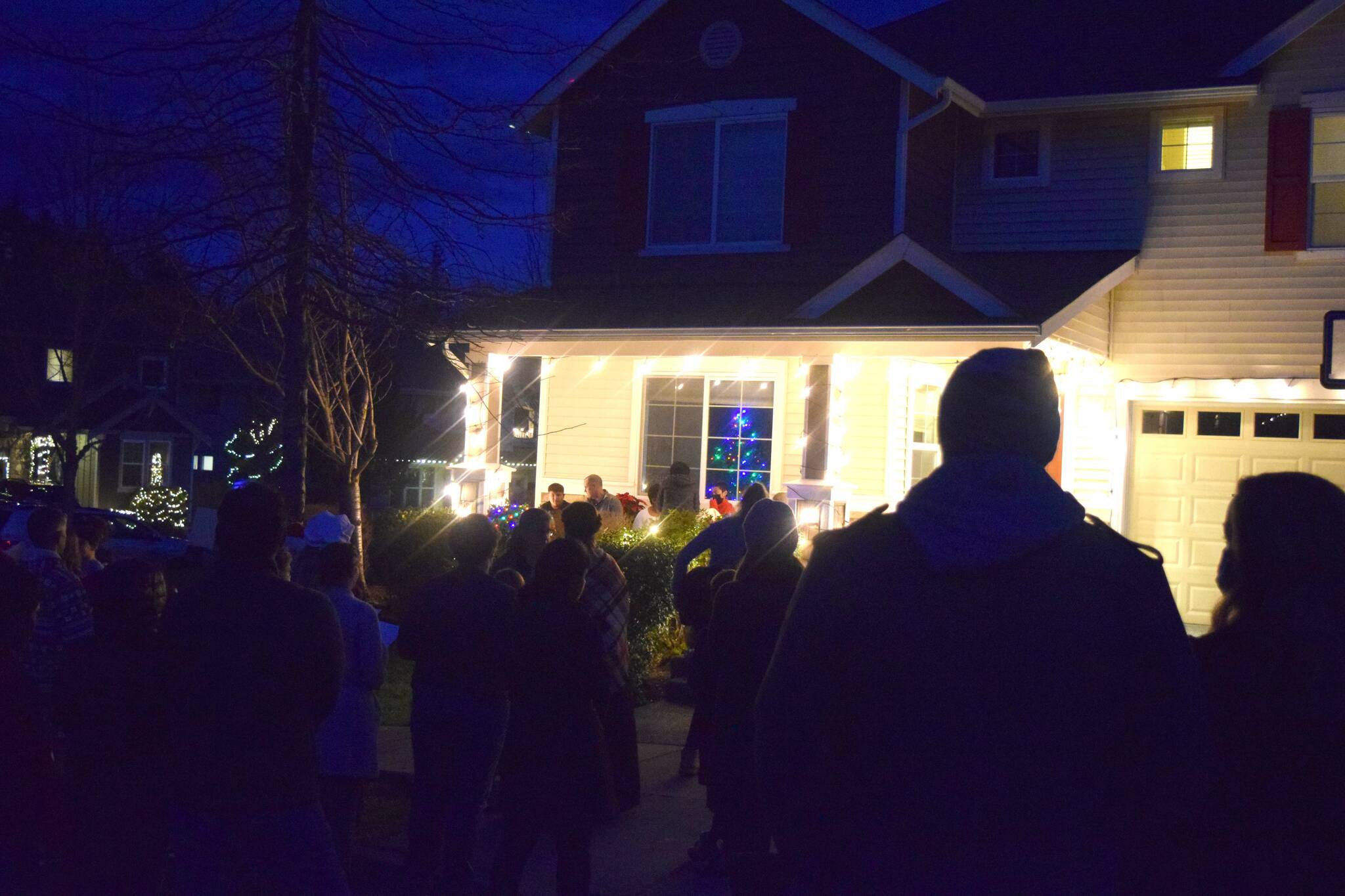 Christmas carolers, led by Valley Center Stage, sing to Zander Wainhouse and his family outside their house in Snoqualmie on Nov. 29. Zander was diagnosed with brain cancer in Dec. 2020. Photo Conor Wilson/Valley Record