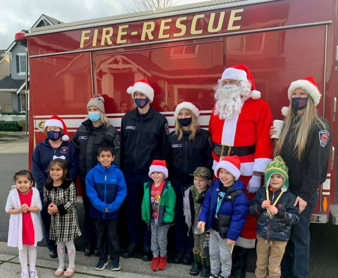 Snoqualmie Fire Association and Santa Claus visit Snoqualmie families. Photo courtesy of Snoqualmie Firefighters Association.