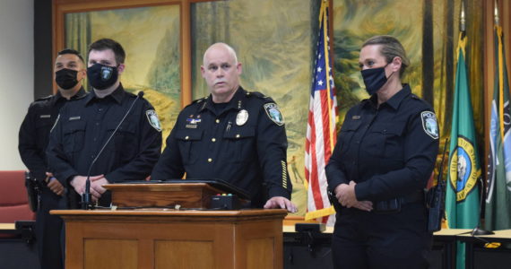 James Aquirre (middle left) being sworn in by Police Chief Perry Phipps (middle right) at a city council meeting on Aug. 9, 2021. File photo by Conor Wilson/Valley Record