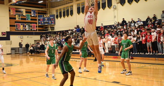 Senior forward Miles Heide goes for a dunk in the KingCo Championship game against Woodinville on Feb. 5. The Wildcats beat the Falcons, 72-42, and were crowned league champions. They will be the top seed in the KingCo/WesCO district tournament. Photo Courtesy of Calder Productions.