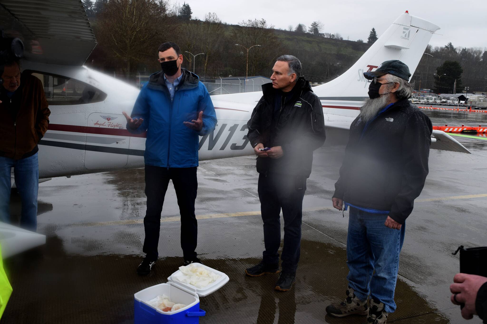 County Executive Dow Constantine (center) speaks outside of a plane that landed at King County Airport March 2, carrying 12,000 kokanee salmon eggs, with Kokanee Work Group Recovery Program Manager Perry Falcone (L) and Snoqualmie Tribal Councilmember Bill Sweet. Photo Conor Wilson/Valley Record.
