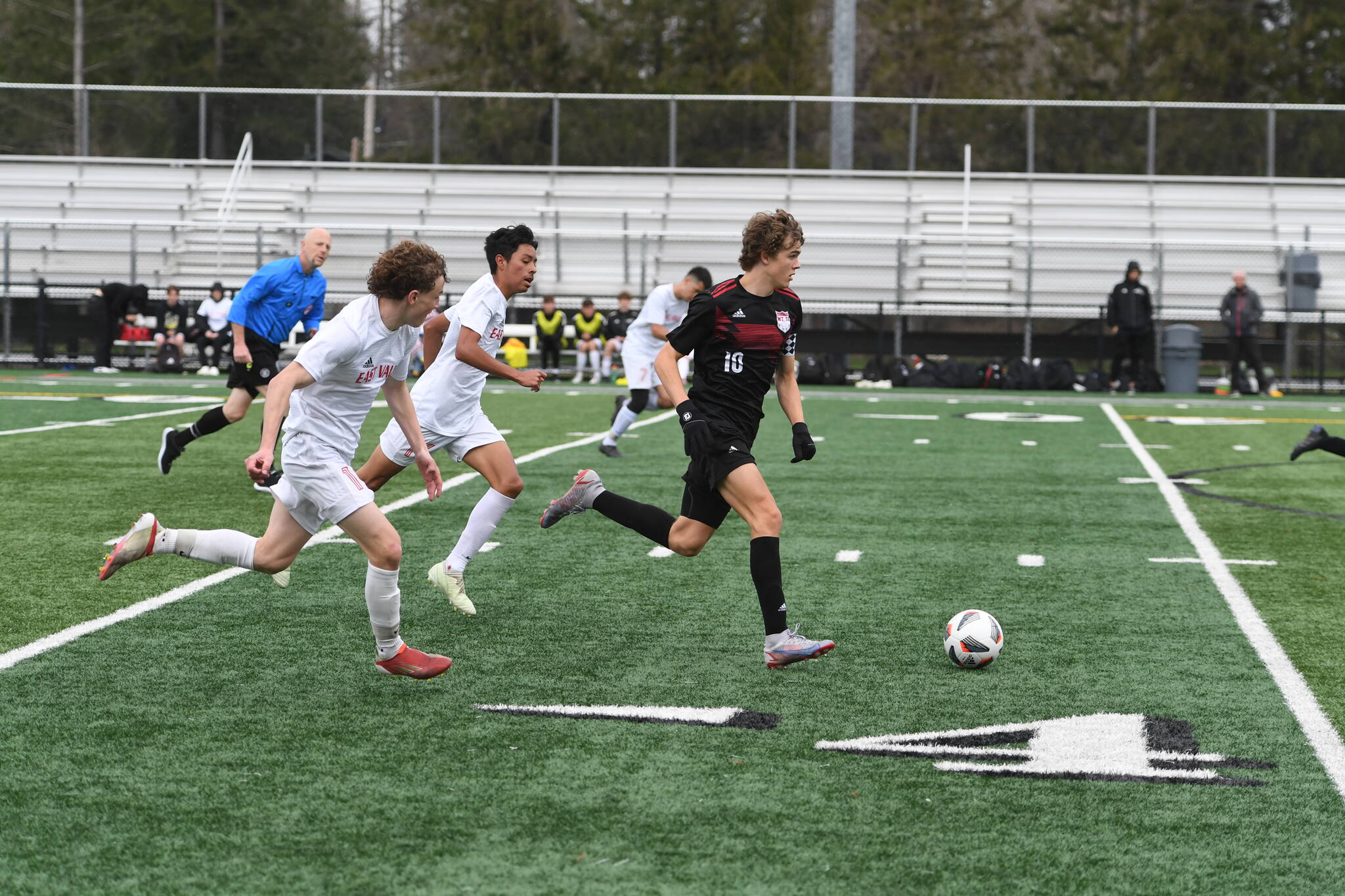 Photo courtesy of Calder Productions. Sophomore Zach Ramsey dribbles past two defenders in a 1-0 lose to East Valley (Yakima) on March 26. The Wildcats are off to a 2-1-2 record this season. They open conference play against North Creek on March 29.