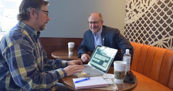 Tad Haas (left) and Rob Wotton sit around a laptop at Starbucks on the Ridge. They serve as president and director of strategic partnerships for the SnoValley Innovation Center. Photo by Conor Wilson/Valley Record