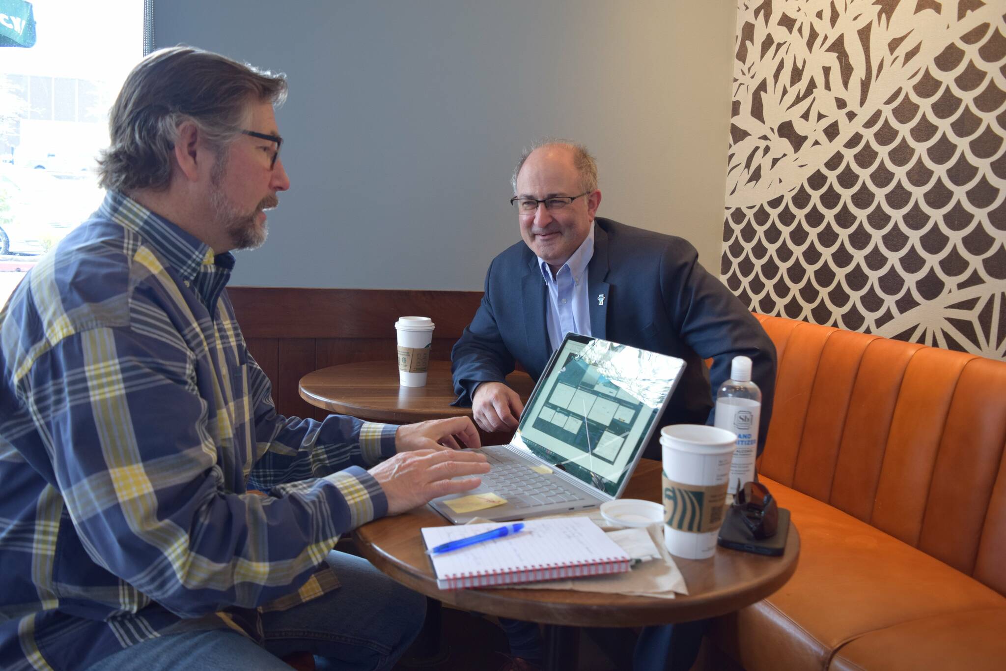 Tad Haas (left) and Rob Wotton sit around a laptop at Starbucks on the Ridge. They serve as president and director of strategic partnerships for the SnoValley Innovation Center. Photo by Conor Wilson/Valley Record