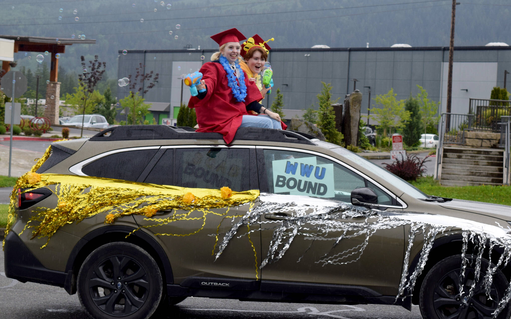 Mount Si High School seniors wave to parade watchers during during the Senior Car Parade on Saturday, June 4. The class of 2022 will hold its graduation Friday, June 10, at the ShoWare Center in Kent. Photo by Conor Wilson/Valley Record.