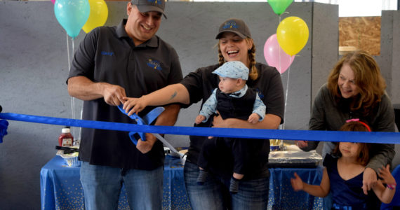 Gary King (left), owner of King’s Quality Auto, and his fiancée, Stefanie Price, celebrate the opening of their new space at 1208 Bendigo Boulevard North in North Bend on June 11. Photo by Conor Wilson/Valley Record