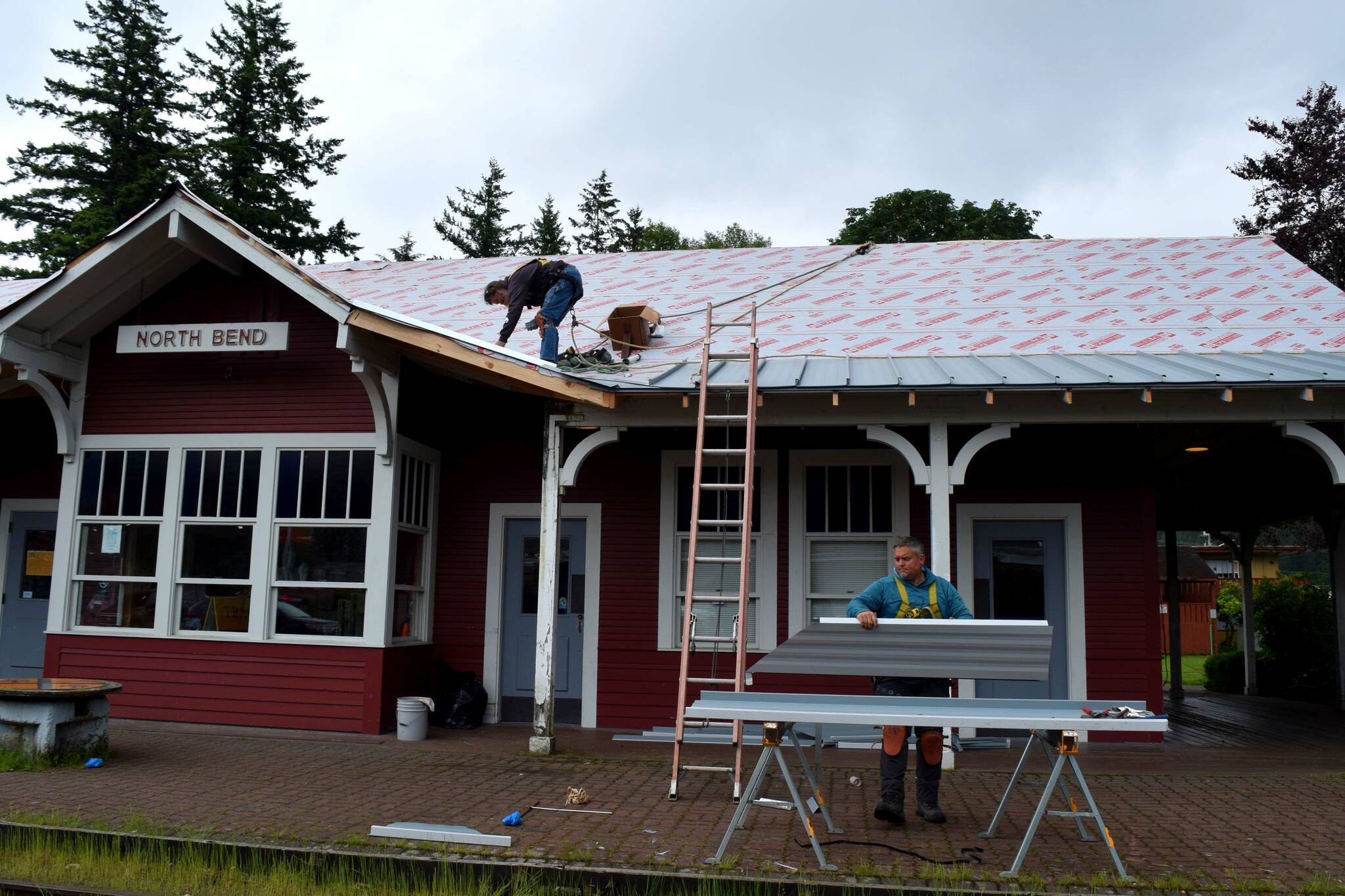 Workers fix the roof at North Bend Train Depot in Taylor Park on June 17. Photo by Conor Wilson/Valley Record