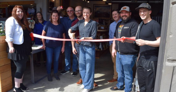 Meghan and David Schumacher (center), owners of Arete Coffee Bar in North Bend, hold a ribbon cutting to celebrate the opening of their business on June 20. Photo Conor Wilson/Valley Record.