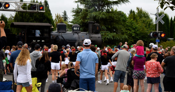 Spectators at Snoqualmie Days watch a train go by on Railroad Avenue. Photo Conor Wilson/Valley Record.
