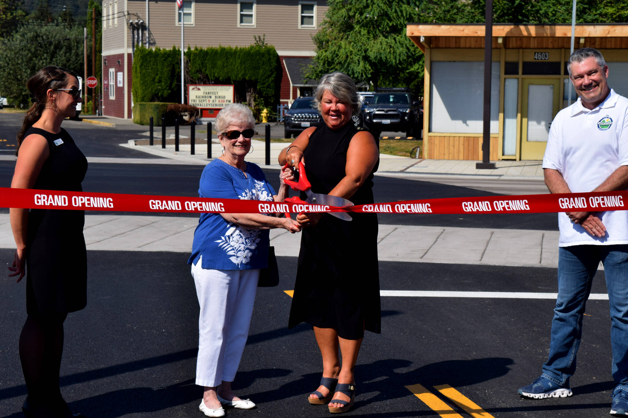 Conor Wilson / Valley Record 
Carnation Mayor Kim Lisk (center right) and Connie Carter celebrate the near end of construction along Tolt Avenue on Aug. 31.