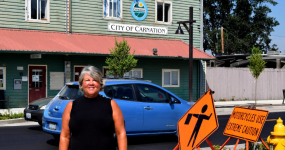Conor Wilson / Valley Record 
Kim Lisk poses in front of City Hall on her last official day as Mayor of Carnation.