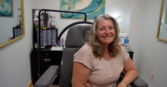 Beverly Davidson, owner of Quill and Ink Tattoo, sits inside her studio located at 111 W. North Bend Way. Photo by Conor Wilson/Valley Record