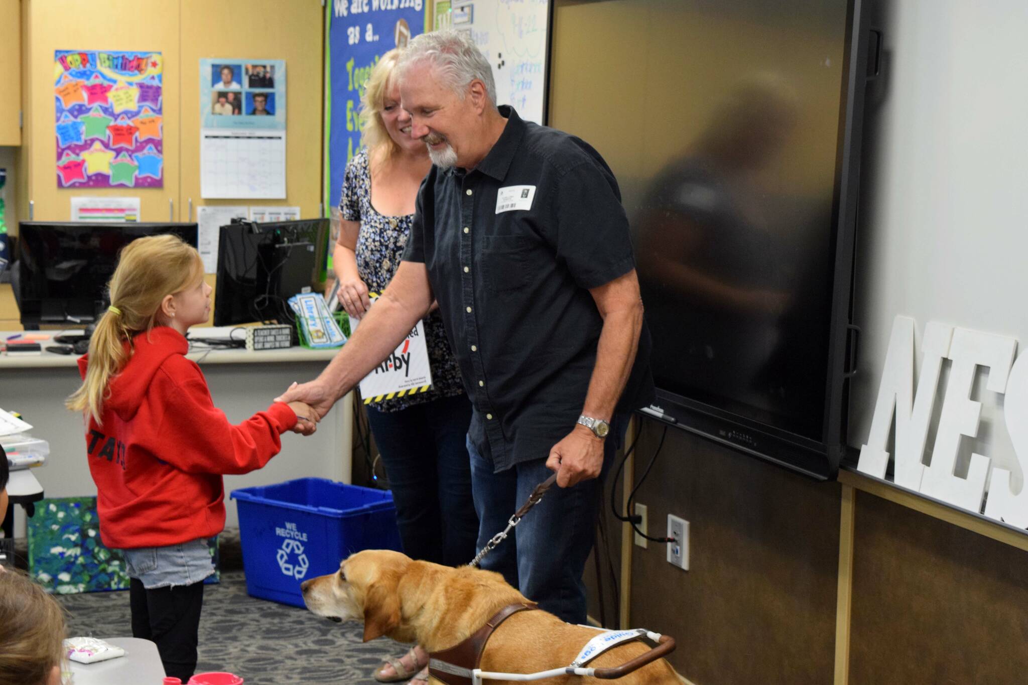 Clark Roberts greets a student at North Bend Elementary on Sept. 16. Photo by Conor Wilson/Valley Record
