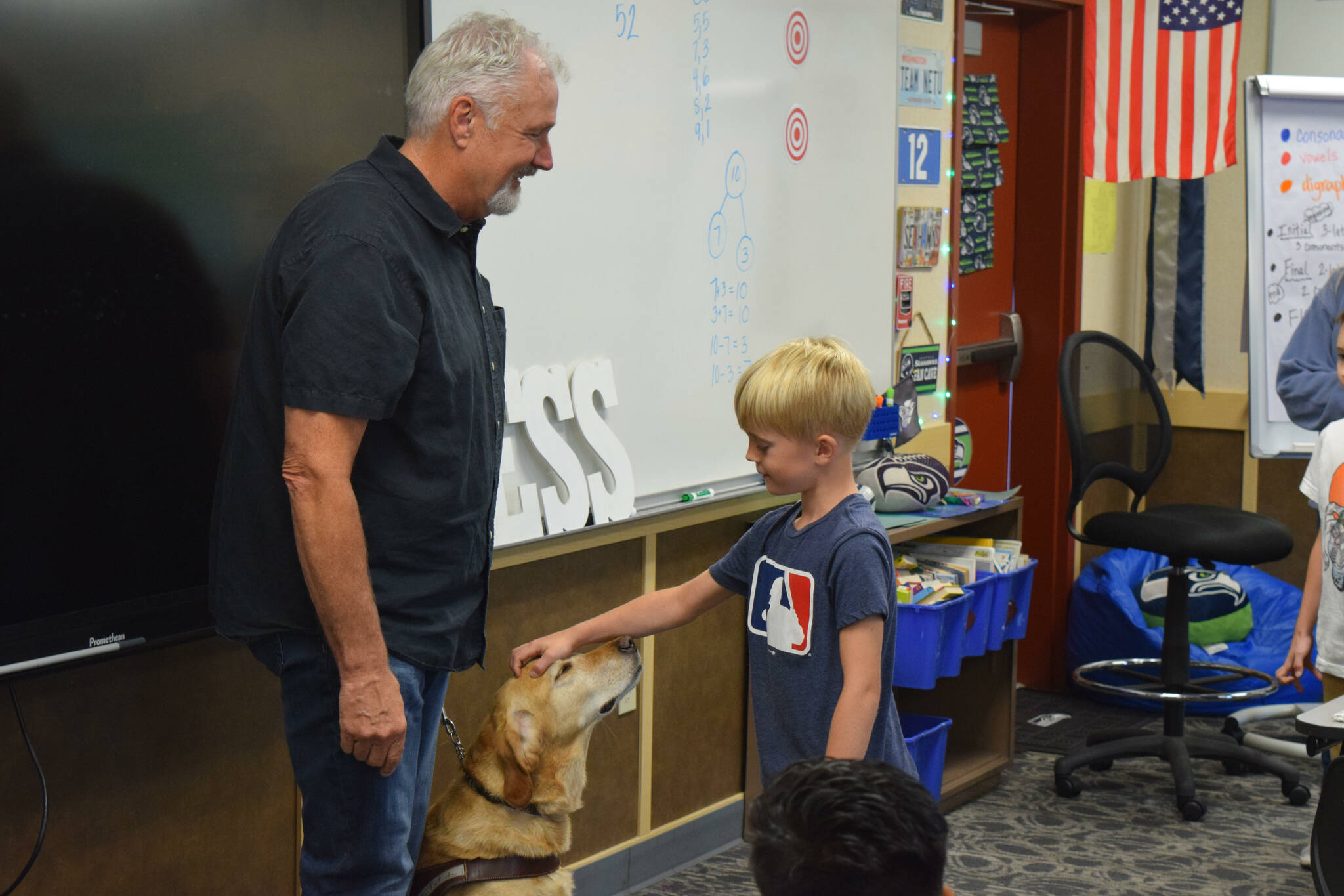 Clark Roberts greets a student at North Bend Elementary on Sept. 16. Photo by Conor Wilson/Valley Record