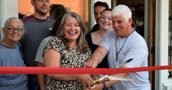 Beverly Davidson, owner of Quill and Ink Tattoo, stands next to family and friends on Oct. 6 as she celebrates the grand opening of her new business in North Bend. Photo Conor Wilson/Valley Record.