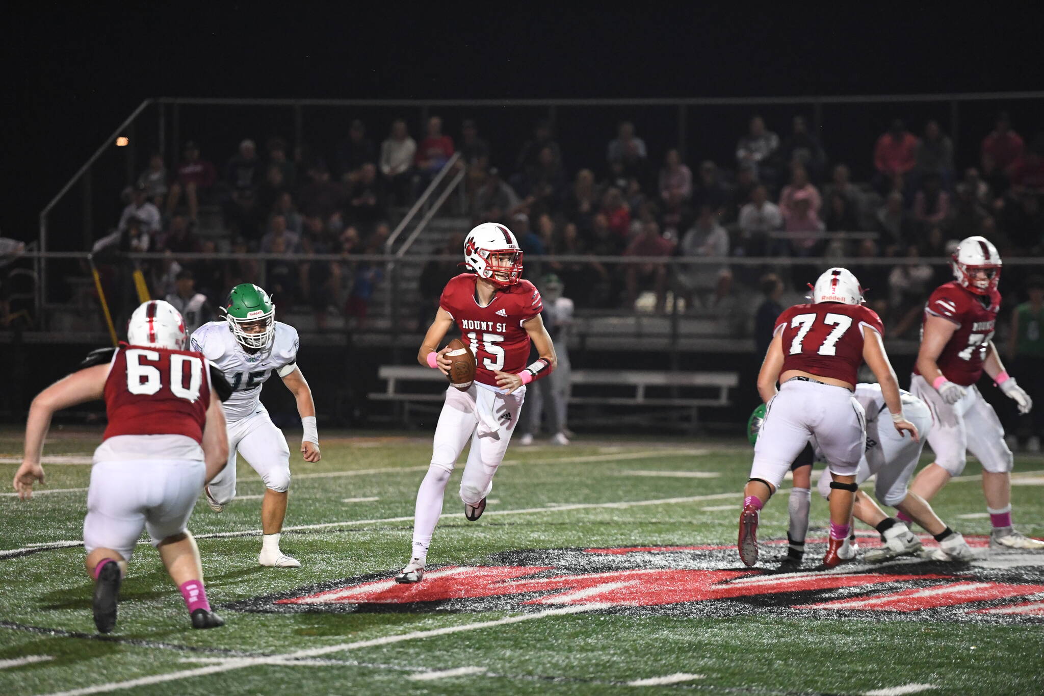 Photo courtesy of Calder Productions. Senior Quarterback Cyrus Turley scrambles in a 26-0 win over Woodinville on Oct 7.