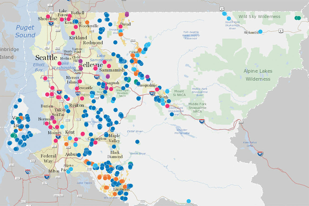 A map of various Land Conservation Initiative projects in King County. Dark blue spots represent natural lands; light blue, rivers; green, forests; pink, urban green space; purple, regional trails; and yellow, farmland. Map courtesy King County
